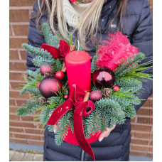 Christmas composition in a pot with one red candle