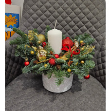 Christmas composition in a pot with one white candle